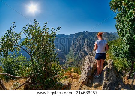 Young Woman at the edge of Mountain Gorge near Tatev Monastery in Armenia