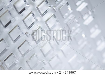 Abstract high-tech background. A sheet of transparent plastic or glass with the cut out holes. Laser cutting of plexiglass.