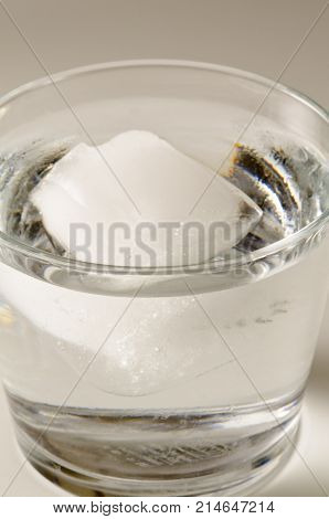 Physics. Ice cube floating in a glass of water.