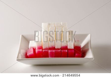 Physics. Capillary action. Dyed water is going up sugar cube tower. 