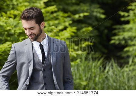midage Happy businessman smiling and looking down