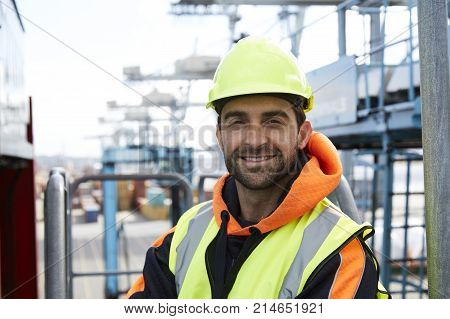 Happy docker in hardhat smiling to camera