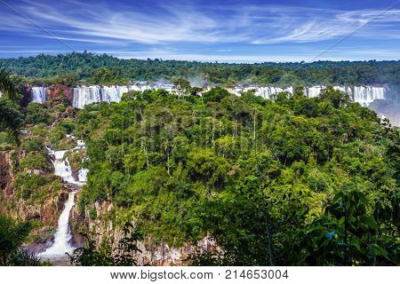 Grandiose multi-level waterfalls Iguasu in the tropical jungle of South America. Concept of active and extreme tourism
