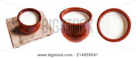 Yogurt cream or Cottage cheese curd in clay pot isolated on a white background. Traditional Cuajada sour cream