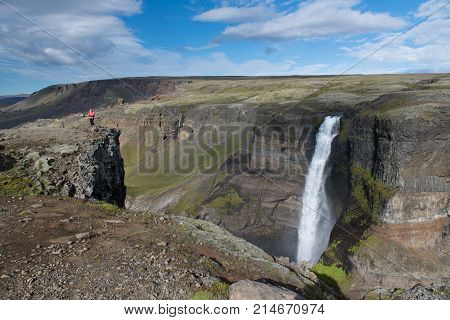 Beautiful view of Haifoss waterfall with adventure woman - Iceland