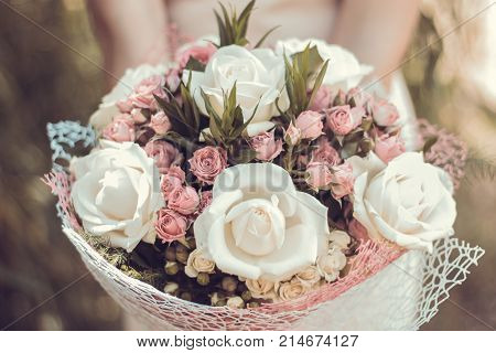 Wedding bouquet in the hands of the bride