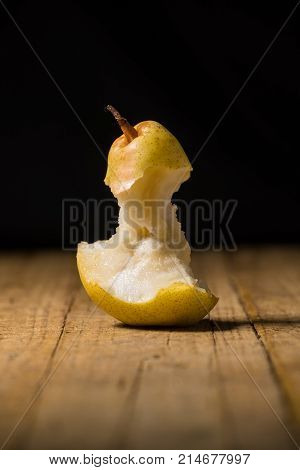 Pear bitten on an old wooden table