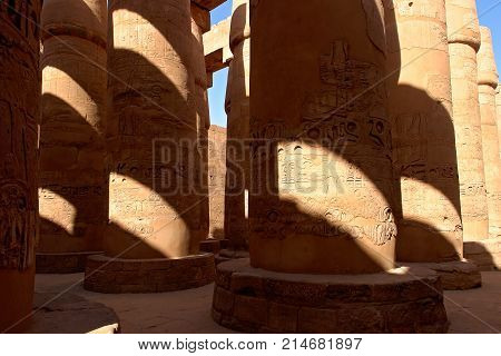 Columns covered with hieroglyphics in majestic hypostyle hall at Karnak Temple - Luxor, Egypt
