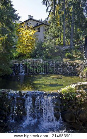 Old park Tsarska or Royal Bistritsa with terraced river, waterfall and differently trees in the venerable autumnal 
forest near by  resort  Borovets, Rila mountain, Bulgaria