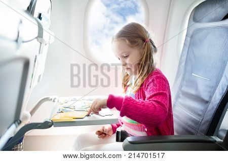 Child In Airplane. Fly With Family. Kids Travel.