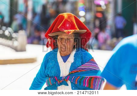 HUARAZ, PERU - JULY 27: Traditionally dressed peruvian people sell fruits and vegetables on the street market on July 27, 2017 in Huaraz, Peru.