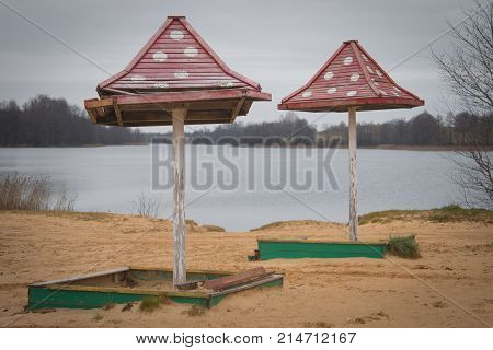 Beach Wooden Umbrellas On The Beach With A Red Roof.