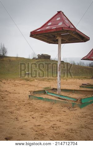 Beach Wooden Umbrellas On The Beach With A Red Roof.