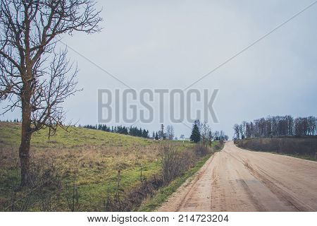 Sharp Turn With Warning Sign On A Gravel Road.