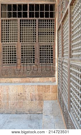 Wooden ornate windows over stone brick wall Old Cairo Egypt