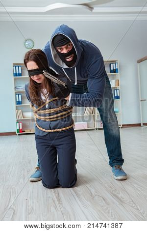 Criminal taking businesswoman as hostage in office