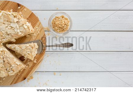 Portion of classic Napoleon cake top view. Traditional millefeuille dessert with puff pastry and custard, russian cuisine treat, copy space
