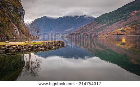 Stunning scenery of norwegian fiord as seen from the shore in small village Flam, Norway