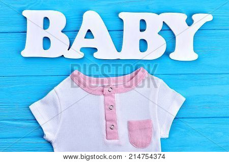 Word baby and cotton baby t-shirt. Toddler girl beautiful organic summer clothes in kids store. Infant baby summer fashion background.