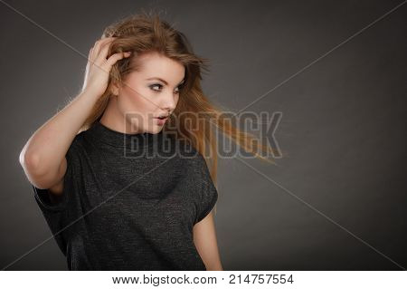 Perfect beauty. Young attractive glamorous female model studio shot. Gorgeous charming blonde woman with make up and waving hair looking seductive.