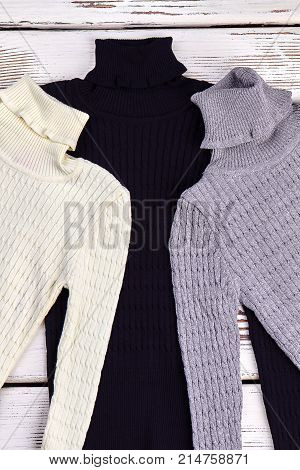 New collection of warm winter sweaters. Turtleneck knittted colored sweaters for children on sale. High quality knitwear.