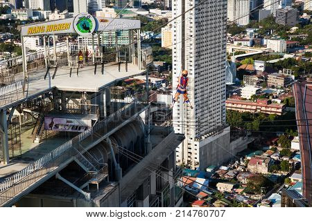 CEBU, PHILIPPINES-MARCH 25, 2016: Hang Higher- The world's first urban sky zip at  Crown Regency on March 25, 2016. Cebu city. Philippines. It's zip line goes between two buildings at the 37th floor.