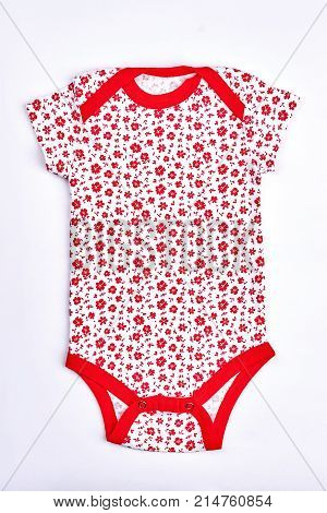 Infant girl white and red bodysuit. Baby-girl white cotton bodysuit wih a pattern of small red frowers isolated on white background.