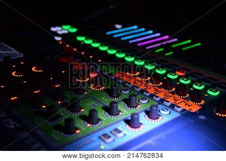 Close up of lighting buttons and sliders on mix pult. Music and sound theme.