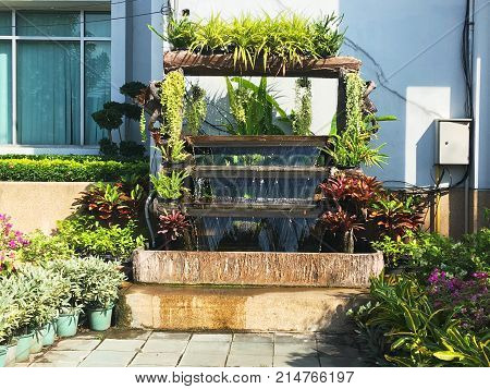 Artificial small vertical waterfall for decorated garden at outside office building to relax.