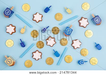 Blue Background With Multicolor Dreidels, Menora Candles And Chocolate Coins. Hanukkah And Judaic Ho