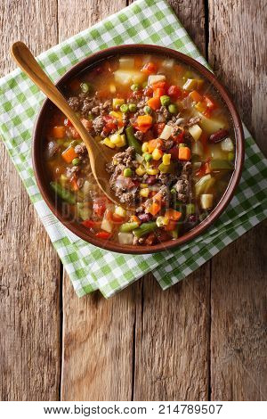 Vegetable Soup With Ground Beef Close-up In A Bowl. Vertical Top View
