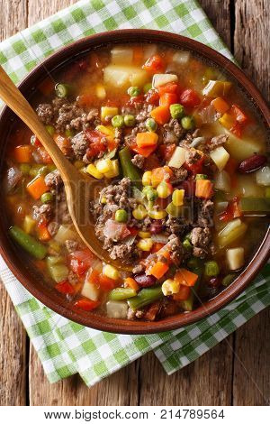 Delicious Hamburger Soup With Ground Beef And Mix Of Vegetables Close-up. Vertical Top View