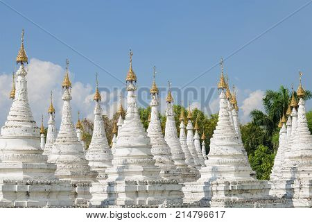 A view of the stupas on the Sandamuni pagoda on a Sunny day. Mandalay, Myanmar