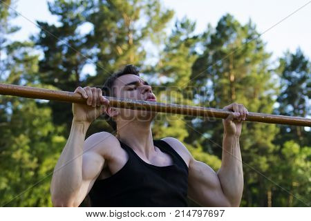 The young man pulled on the bar