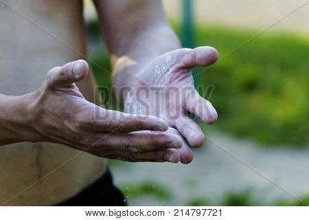 The young man sprinkle his hands with powder