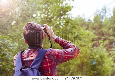 A young man takes photos of nature. Summer-Autumn.