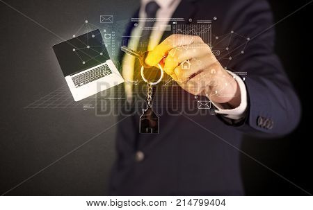 Businessman in suit holding keys with statistics, graphs and icons around