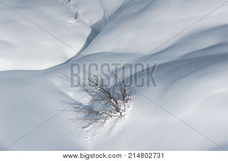 Picturesque landscape of the high mountain peaks covered with snow under the clear blue sky