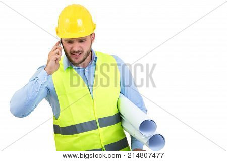 Angry upset young construction engineer yeling at the phone.
