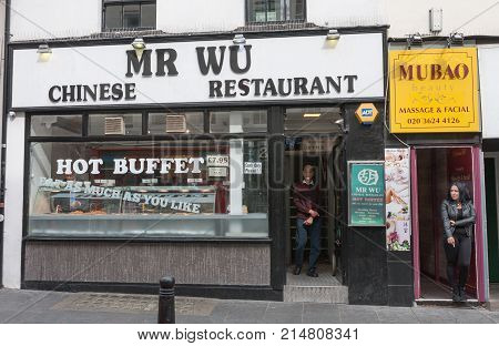 Wardour Street, London-September 6,2017: The head of Mr Wu Chinese Restaurant standing in the door on Wardour Street on September 6, 2017 in London United Kingdom