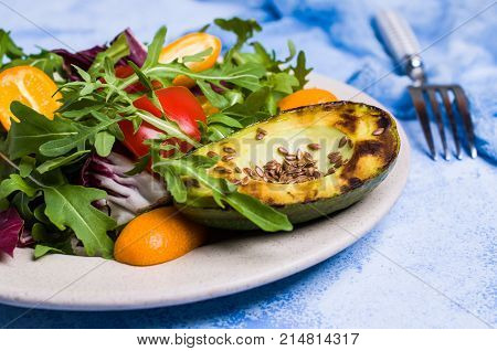 Raw arugula with vegetables and citrus. Selective focus.