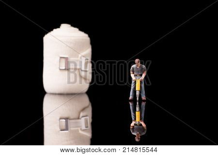 Bandage used for injuries during work leisure time or in housework isolated on glossy black background