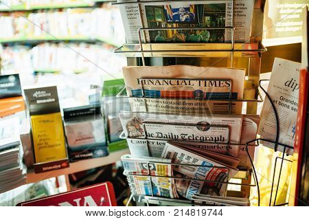 STRASBOURG FRANCE - NOV 21 2017: Newspaper stand with Financial Times The New York Times featuring news about Merkel and Mugabe