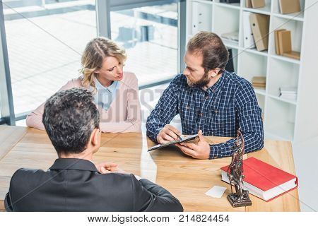 Couple Discussing Contract With Lawyer