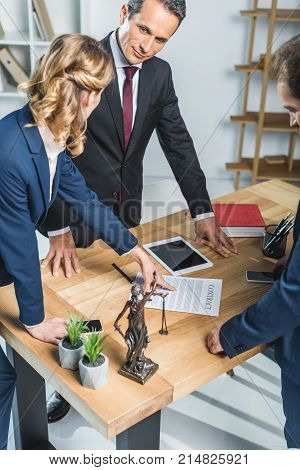 Lawyers Discussing Contract In Office