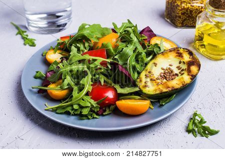 Raw arugula with vegetables and citrus. Selective focus.