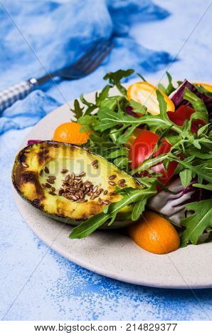Raw arugula with vegetables and citrus. Selective focus.