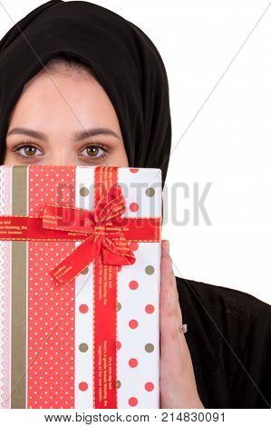 Happy young muslim woman with gift box isolated over white background.