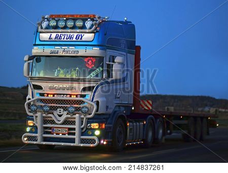 SALO FINLAND - NOVEMBER 17 2017: Beautifully customized Scania R560 semi truck of L. Retva Oy on the road in dusktime in South of Finland.