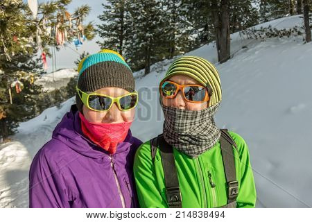 Two Happy Women Traveler With Backpacks Walking In Winter Forest